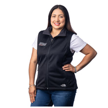 MD Anderson employee wearing a black North Face vest with a full zipper and two front pockets, featuring the full white MD Anderson logo on the right side of the chest and the white North Face logo on the bottom left side.