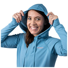 MD Anderson employee wearing a blue hoodie featuring the white cancer strikethrough logo on the upper left chest area.