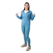 MD Anderson employee wearing the matching blue hoodie and tights, both featuring thee white cancer strikethrough logo.