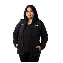 MD Anderson employee wearing a black North Face zip-up jacket with front zippered pockets featuring the full white MD Anderson logo on the top right chest area and the white North Face logo on the top left chest area.