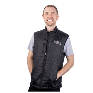 MD Anderson employee wearing a black puffy zippered vest with front pockets featuring the full white MD Anderson logo on the top left chest area.