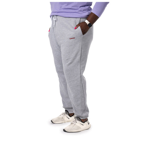 MD Anderson employee wearing gray fleece joggers featuring the black cancer strikethrough logo on the upper left thigh area.