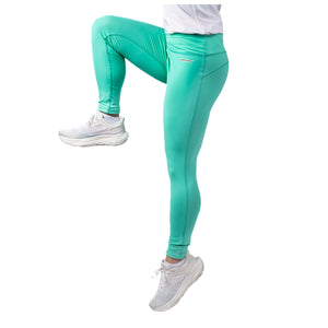 MD Anderson employee wearing turquoise leggings featuring the white cancer strikethrough logo on the hip band.