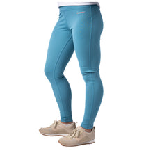 MD Anderson employee wearing lagoon blue leggings featuring the white cancer strikethrough logo on the hip band.