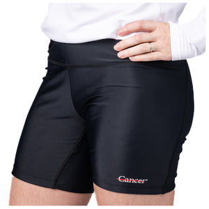 MD Anderson employee wearing black shorts featuring the black cancer strikethrough logo at the bottom left seam.