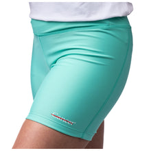 MD Anderson employee wearing turquoise shorts featuring the white cancer strikethrough logo at the bottom left seam.