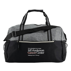 Grey and black duffle bag with handles, front zipper, and featuring the white MD Anderson logo.