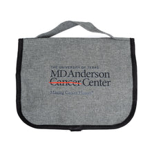 Front of gray toiletry bag featuring the full black MD Anderson logo in the front.