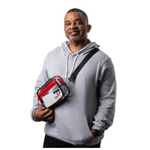 MD Anderson employee wearing a clear PVC belt bag with red zipper trim and black adjustable strap featuring the black Cancer strikethrough logo on the front panel.