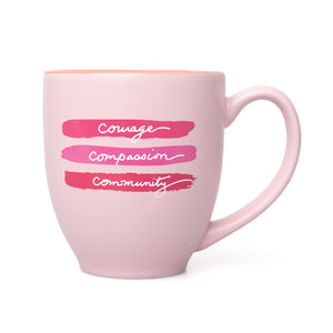 Pink mug featuring the words "courage, compassion, and community".