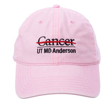 Baseball cap in pink featuring the full black UT MD Anderson logo embroidered on the front.