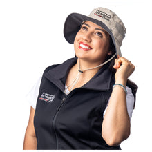 MD Anderson employee wearing a tan Columbia hat featuring the full black MD Anderson logo.