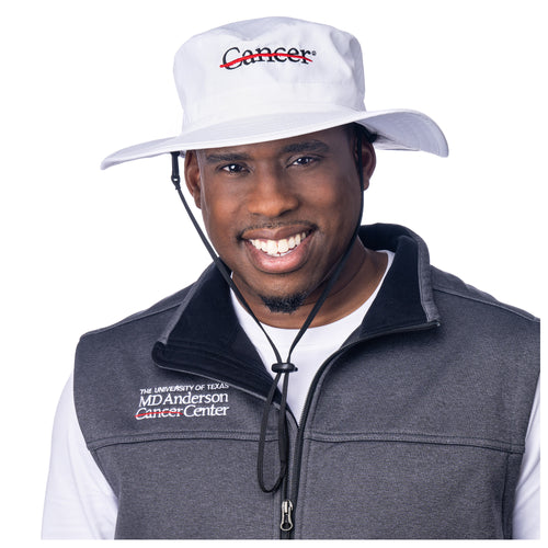 MD Anderson employee wearing a white brim hat featuring the black cancer strikethrough logo.