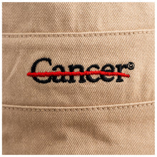 Closeup of black cancer strikethrough logo.