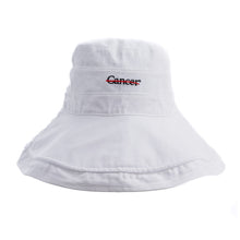 White bucket hat featuring the black cancer strikethrough logo in the middle.