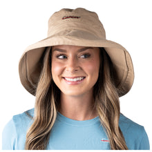 MD Anderson employee wearing a tan bucket hat featuring the black cancer strikethrough logo in the middle.