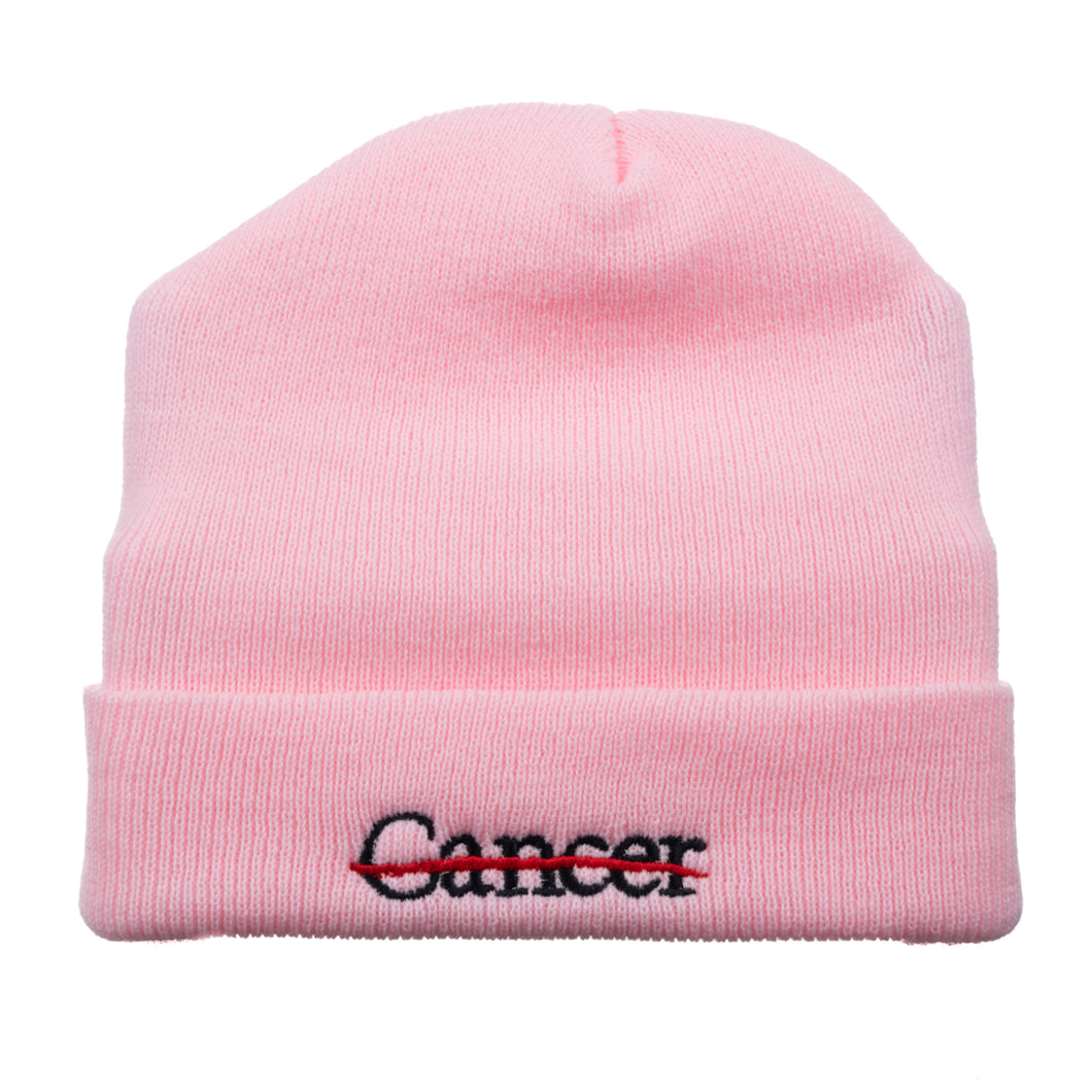 Pink beanie featuring the black cancer strikethrough logo.