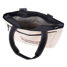 Cooler tote in natural color featuring black straps and the full black UT MD Anderson logo printed on the front zippered pocket, shown open to reveal the insulated main compartment.