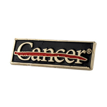 Metal black lapel pin engraved with the cancer strikethrough logo in gold.