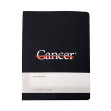 Cover of black Moleskine journal with the white cancer strikethrough logo in the middle.