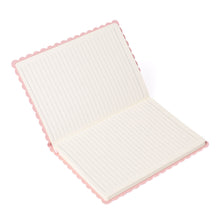 Open scalloped journal with lined pages.