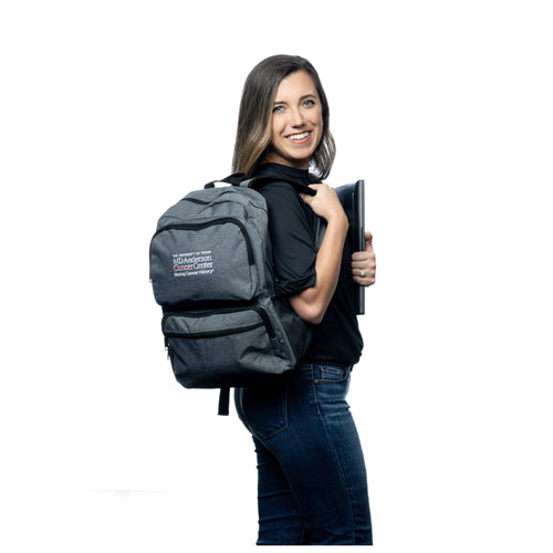 MD Anderson employee wearing a grey backpack with front pockets, featuring the white MD Anderson logo.