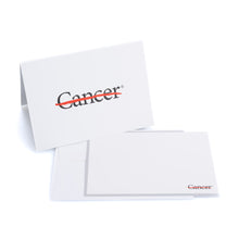 White notecard featuring the black cancer strikethrough logo in the middle, along with one white envelope.