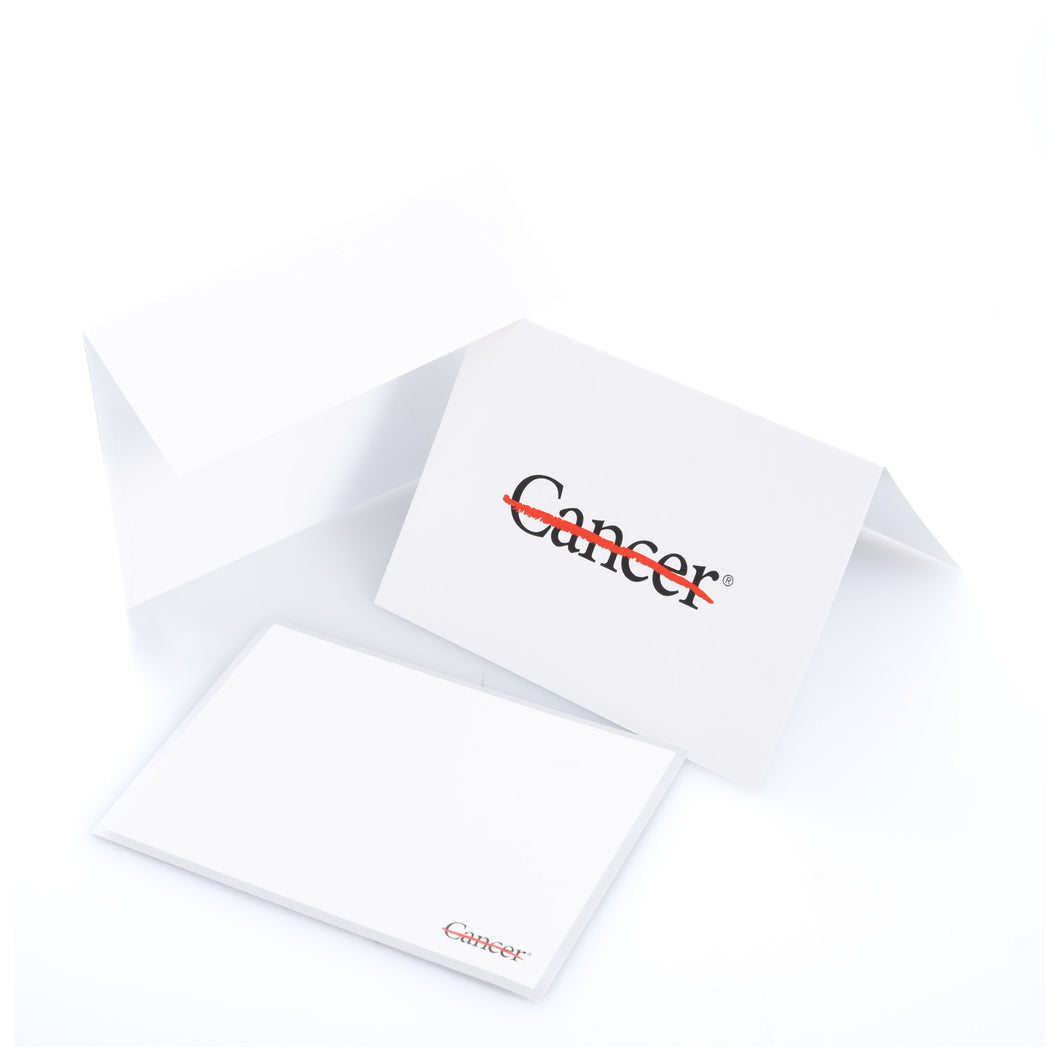 White notecard featuring the black cancer strikethrough logo in the middle, along with one white envelope.