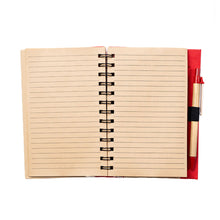 Open hardcover spiral notebook with pen, displaying the lined pages in a khaki color.