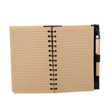 Open hardcover spiral notebook with pen, displaying the lined pages in a khaki color.
