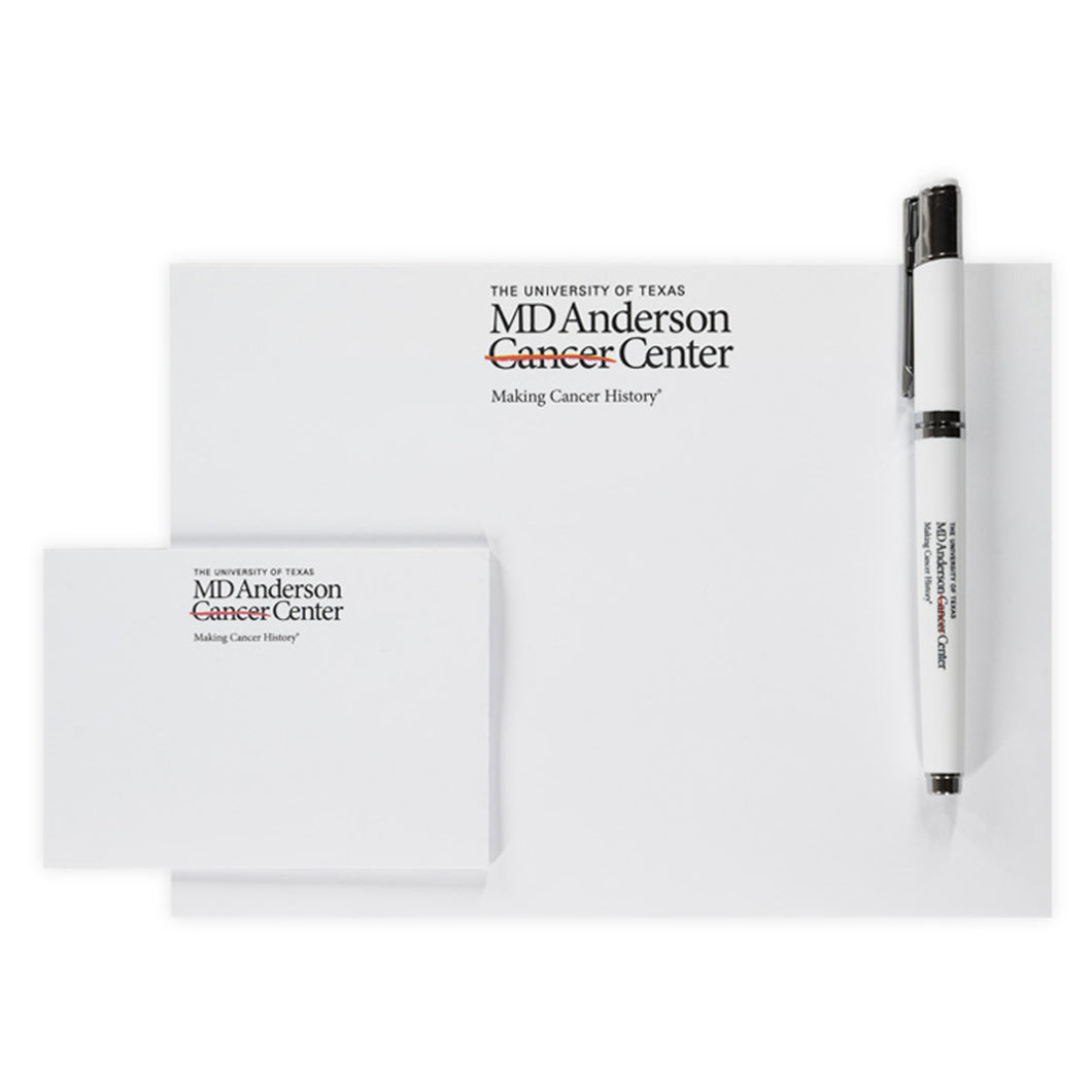 White notepad and pen set featuring the black MD Anderson logo.