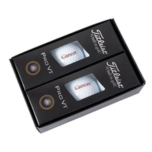 Titleist packaging featuring the white golf balls with the black cancer strikethrough logo.