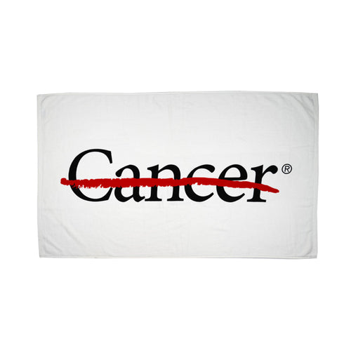 White beach towel featuring the cancer strikethrough logo displayed.