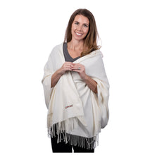 MD Anderson employee wearing a cream pashmina shawl featuring the black cancer strikethrough logo on the bottom corner.