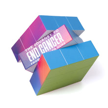 Multicolor Rubik's cube featuring the white tagline "The Journey to End Cancer from Cause to Cure".