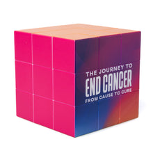 Multicolor Rubik's cube featuring the white tagline "The Journey to End Cancer from Cause to Cure".