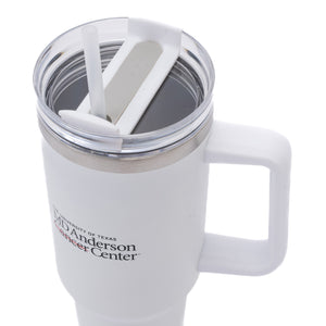 White 40 oz. travel mug with a straw and handle, featuring the black MD Anderson logo on the front.
